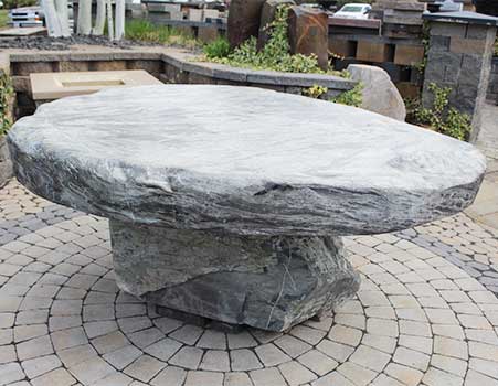 close up of large custom fabricate stone table at Gibson's Hardscape in Spokane, WA