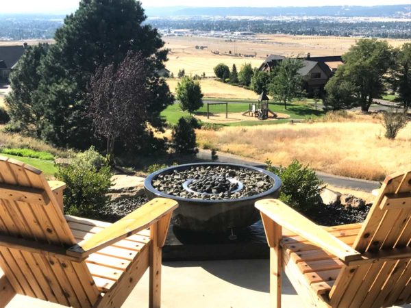 large bowl fire pit with basalt stone and lava rock in center