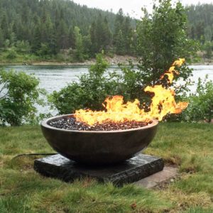 large propane powered fire bowl on edge of property with river view