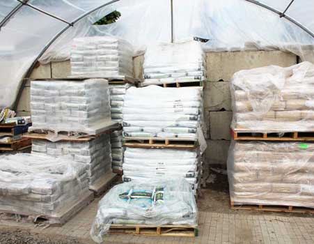 tent with bags of fertilizer on pallets 